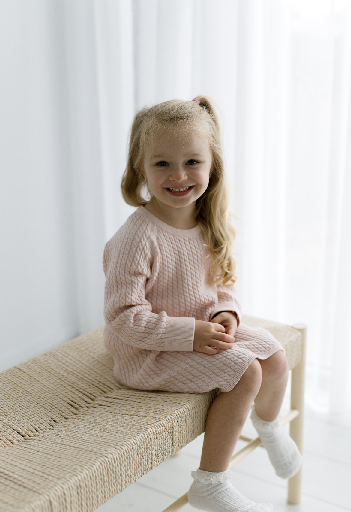 child wearing pink cable knit dress