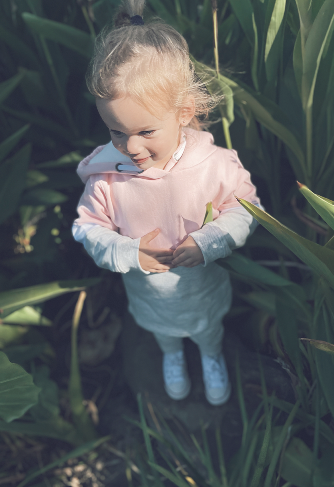 girl wearing cute tracksuit smiling in nature