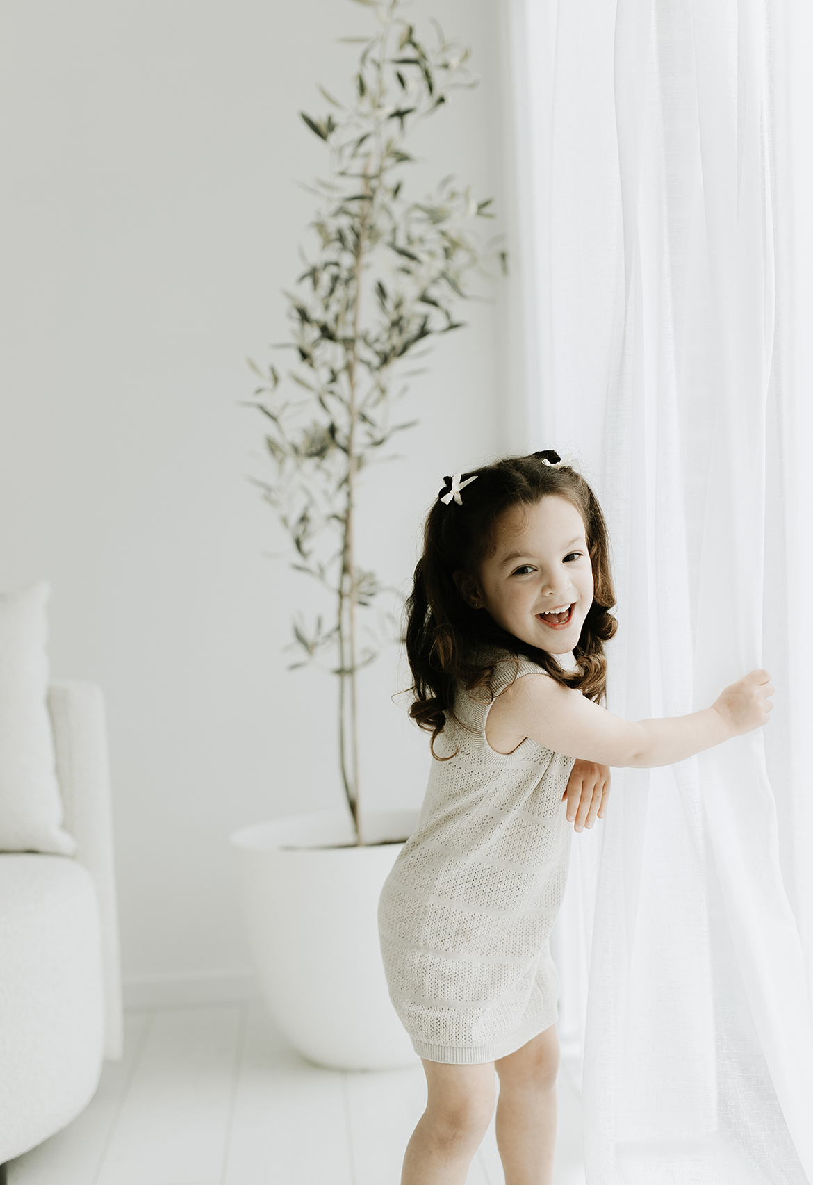 child laughing in stone marle pointelle dress