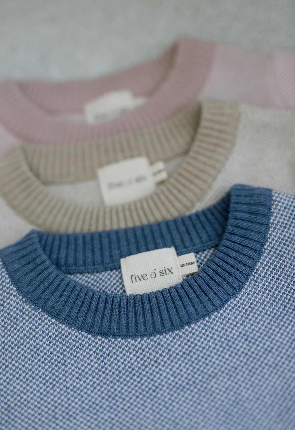 three coloured rompers blue, pink and oatmeal