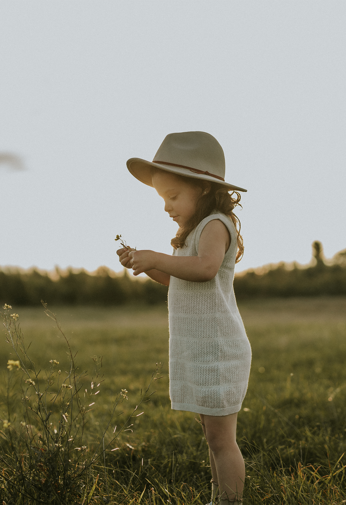 child standing in field paddock in pointelle stone marle dress