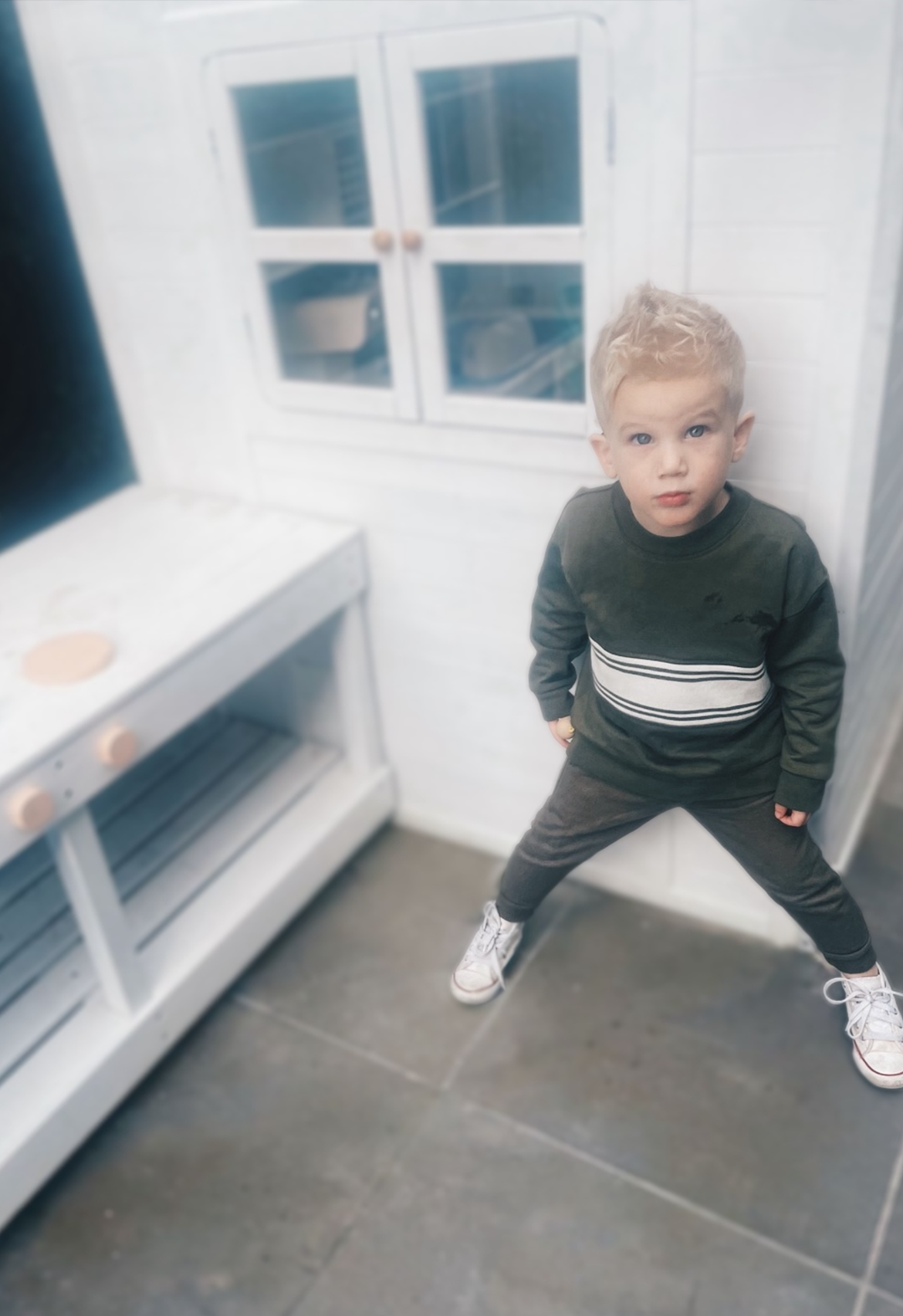 child wearing olive tracksuit