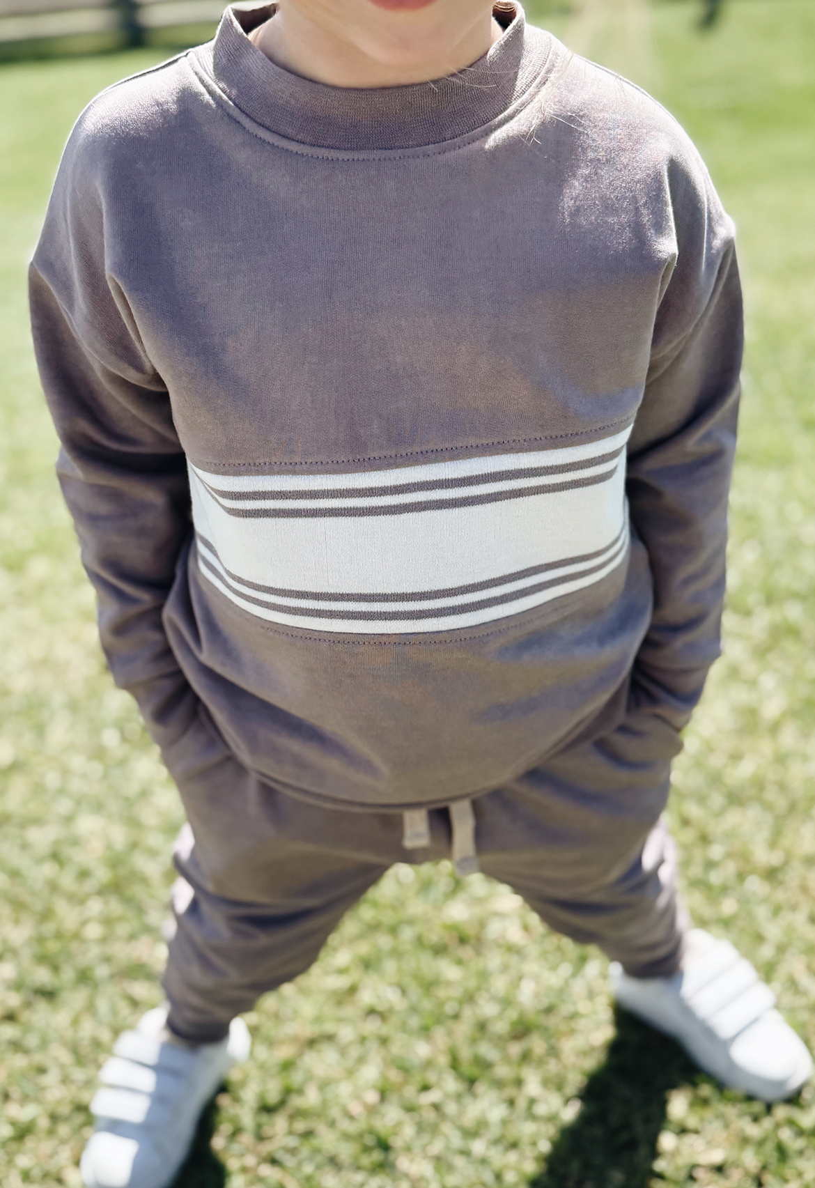 girl showing close up of tracksuit crew jumper