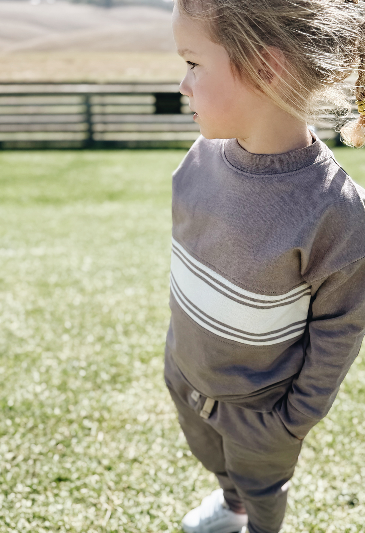 Side perspective of striped dusty purple crew jumper