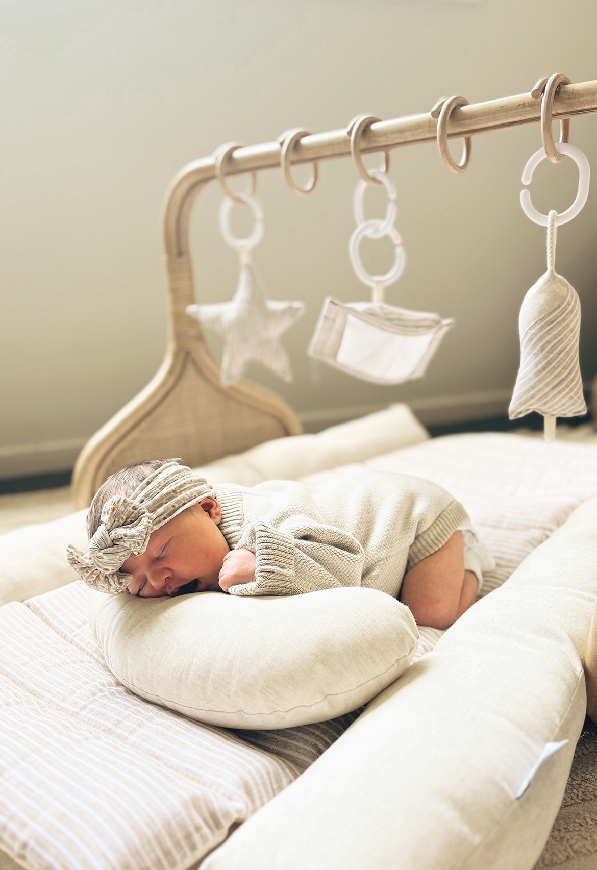 newborn baby in oatmeal romper