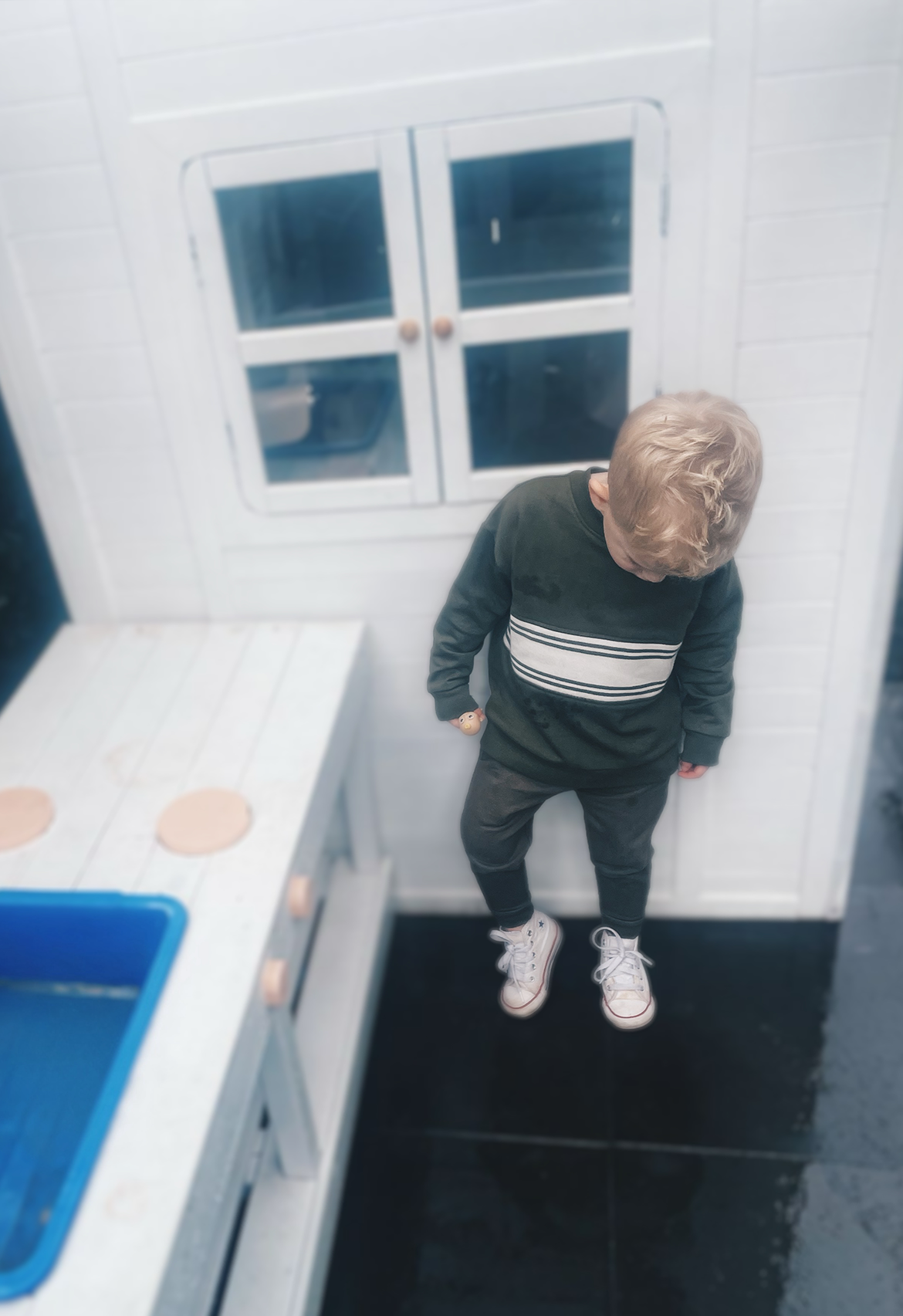 Child standing with tracksuit on